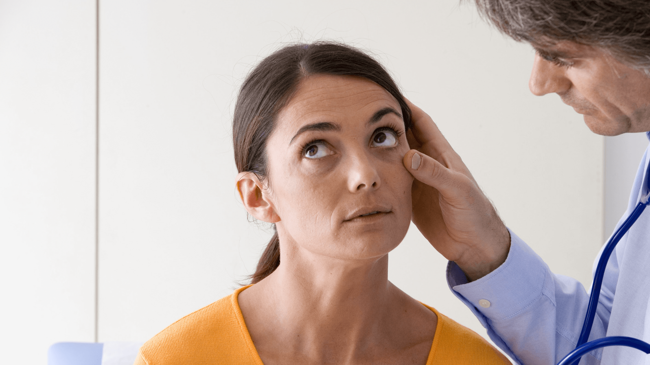 doctor looking in woman's eye